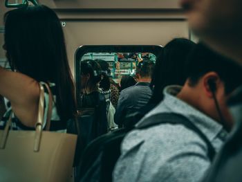 Rear view of people sitting in train