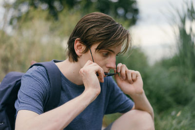 Portrait of young man sitting outdoors