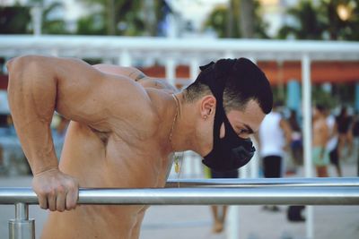 Side view of man exercising on railing 
