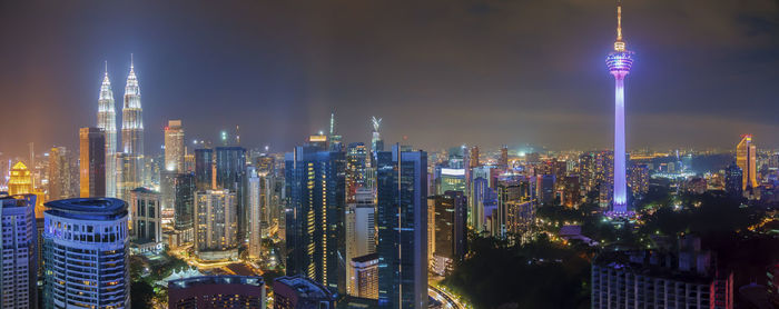 Panoramic view of skyscrapers lit up at night