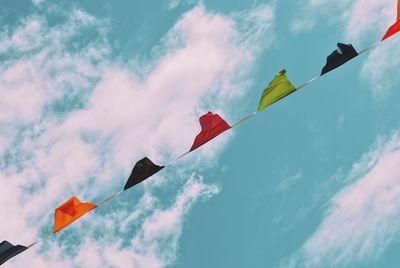 Low angle view of flags against sky