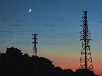 Low angle view of electricity pylon against sky