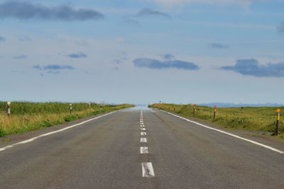 Road passing through landscape against sky