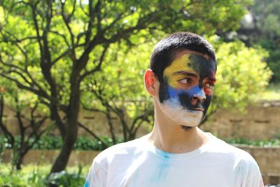 Close-up of teenage boy with face paint at park