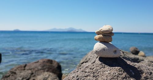 Stack of rocks on beach against sky