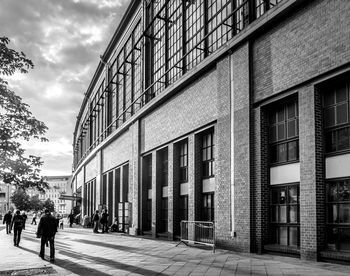Rear view of people walking on street