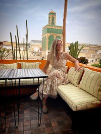 Portrait of woman sitting on chairs at restaurant