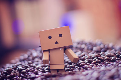 Close-up of danbo figurine amidst roasted coffee beans