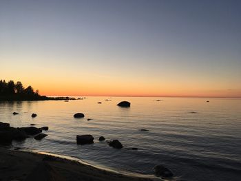 Scenic view of sea against clear sky during sunset