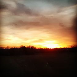 Scenic view of silhouette landscape against sky at sunset