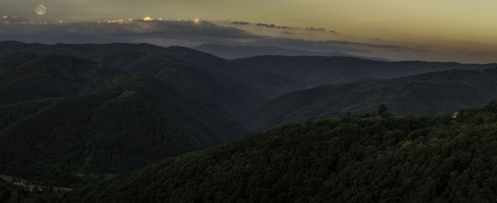 Scenic view of mountains against cloudy sky