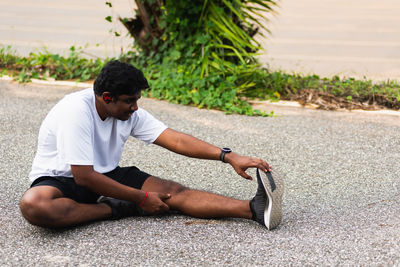 Young man sitting on field