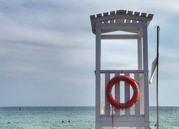 Lifeguard hut on beach against sky