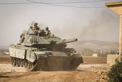 High angle view of soldiers standing on armor tank