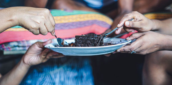 Midsection of woman holding ice cream in bowl