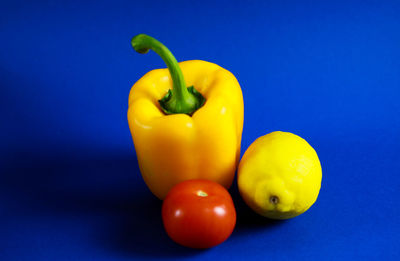 Close-up of yellow bell peppers on blue table