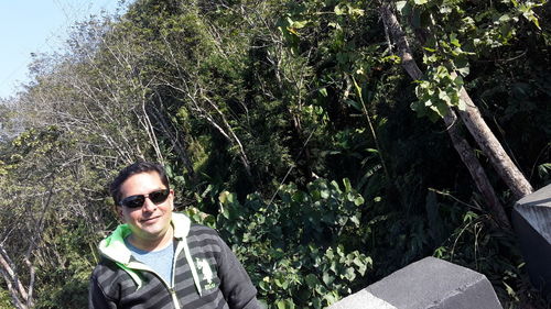 Portrait of smiling man against plants