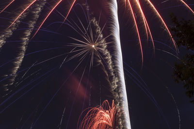 Low angle view of firework display at night