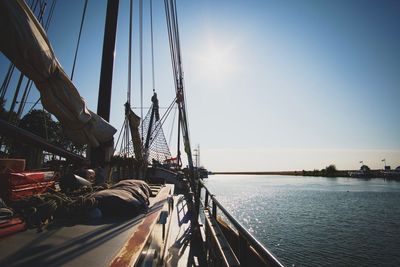 Sailboat sailing on sea against clear sky
