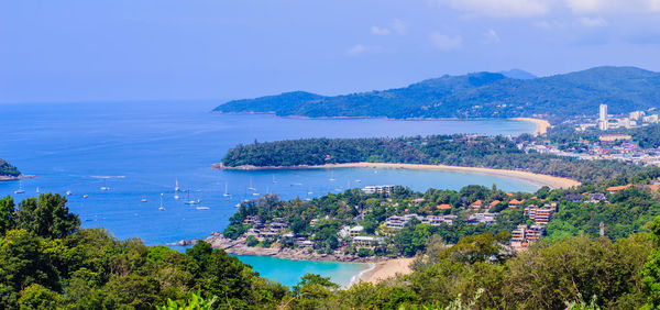 High angle view of cityscape by sea against sky