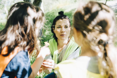 High angle view of teacher talking with girls in playground