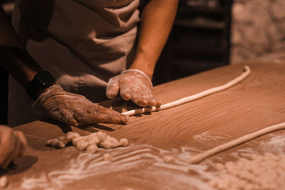 Midsection of man working on wood