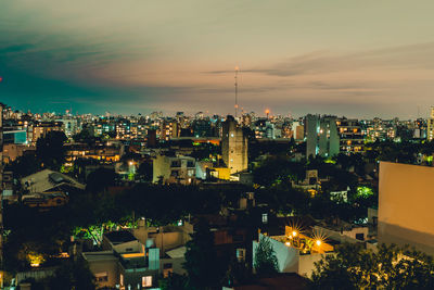 High angle view of illuminated buildings against sky at sunset