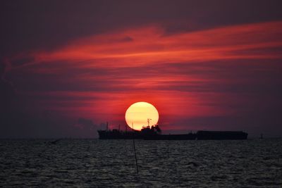 Scenic view of sea against orange sky