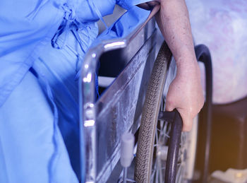 Midsection of woman sitting on wheelchair