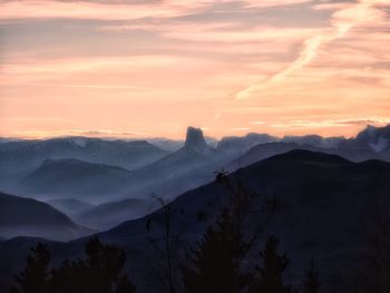 Scenic view of snowcapped mountains against sky during sunset