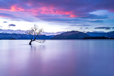 Scenic view of lake against sky during sunset