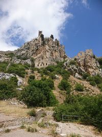 Low angle view of rocks on mountain against sky