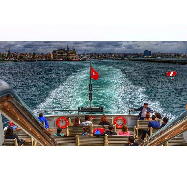 water, sea, transportation, lifestyles, men, transfer print, leisure activity, railing, person, built structure, nautical vessel, mode of transport, river, auto post production filter, travel, high angle view, standing, architecture, day