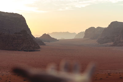 Scenic view of desert against sky during sunset