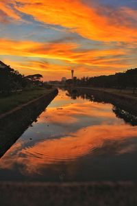 Scenic view of lake against orange sky