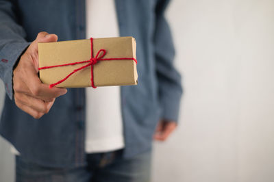 Close-up of man holding paper box