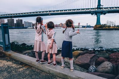 People standing on bridge over river