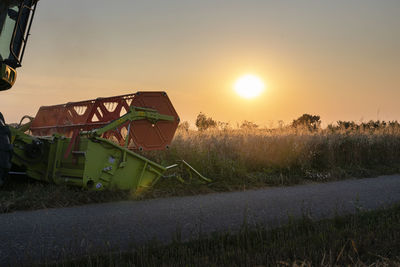 Organic farming, wheat field, harvest, combine harvester in the evening