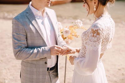 Midsection of bridegroom during wedding ceremony