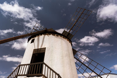 Low angle view of traditional windmill against sky