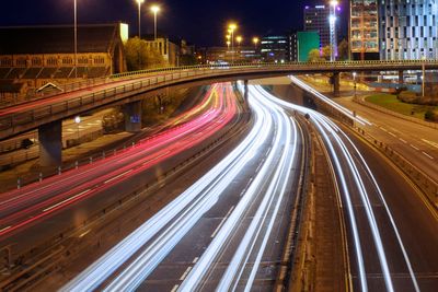 High angle view of light trails over street at night in city