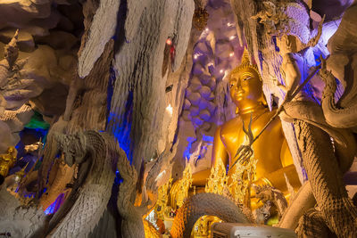 Low angle view of statue against illuminated building