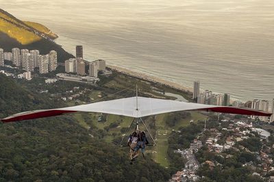 High angle view of people in city by sea