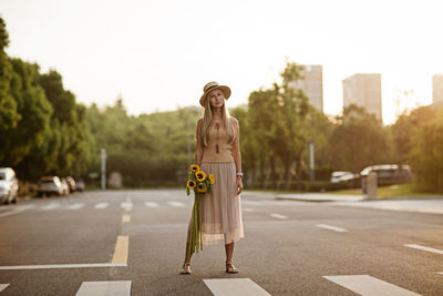 Rear view of woman walking on road