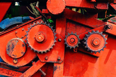 Old red wheel mechanism of combine. gears. old equipment.