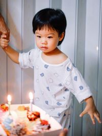 Portrait of cute girl playing with birthday cake