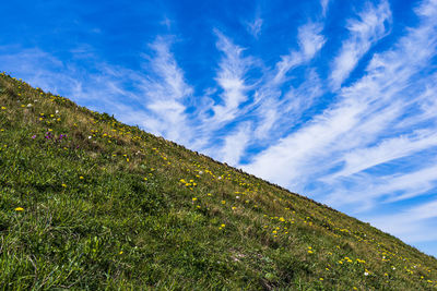 Low angle view of mountain against blue sky