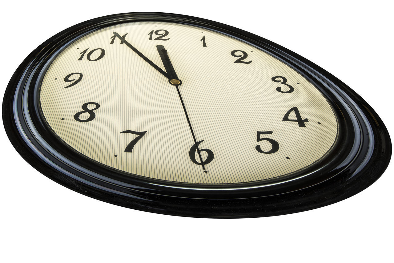 CLOSE-UP OF CLOCK ON WHITE BACKGROUND