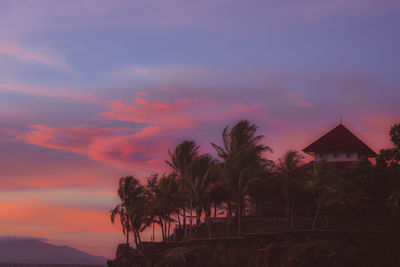 Silhouette palm trees against sky during sunset
