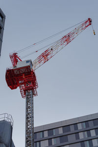 Low angle view of crane against sky